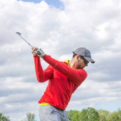 Man Midswing wearing Golf Sunglasses - Ultimate guide to Golf sunglasses